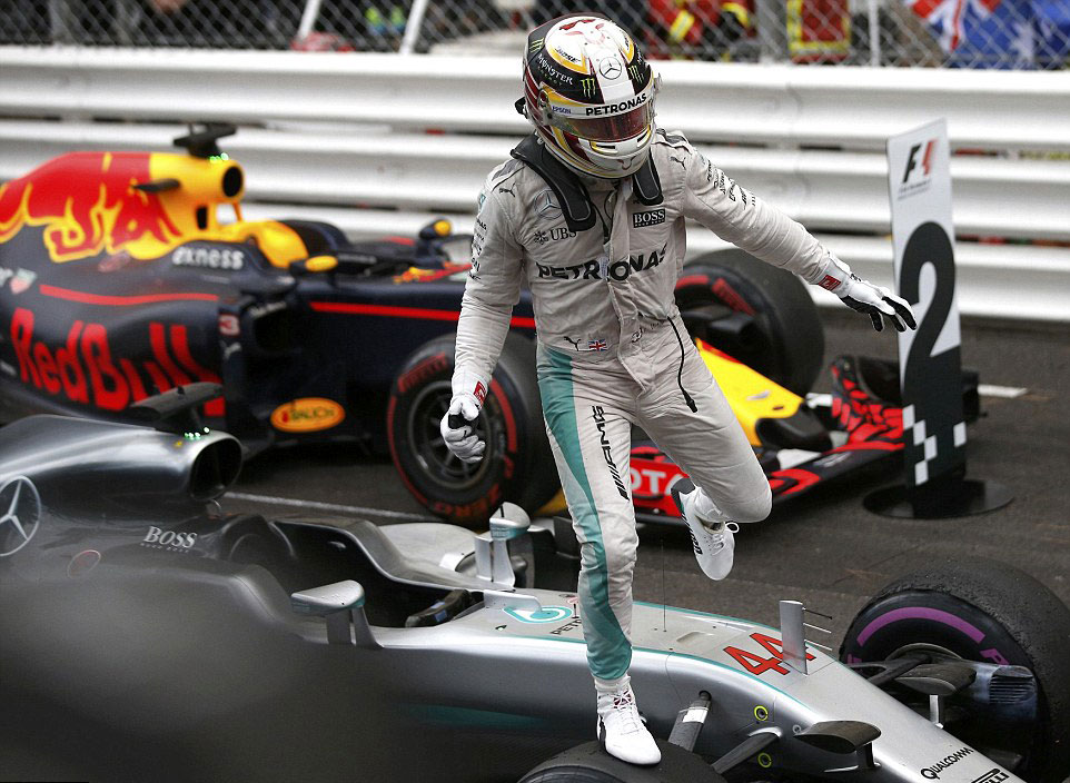 Hamilton jumps out of his car after his remarkable performance (Credit: Reuters)