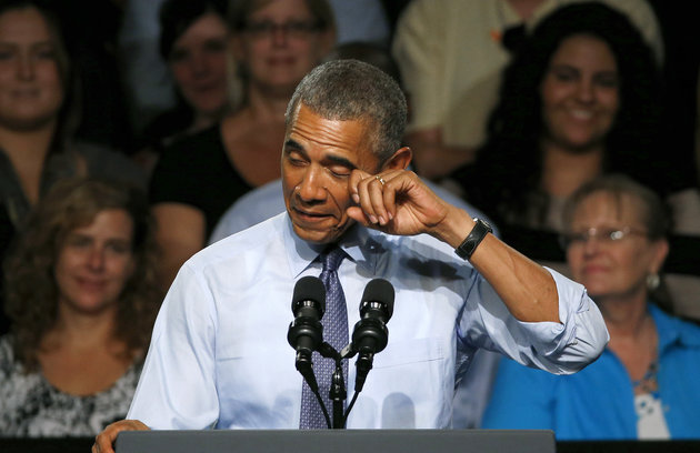President Barack Obama pretends to wipe a tear during his speech at Macomb County Community College Wednesday, Sept. 9, 2015, in Warren, Mich. The president said he's "a little freaked out" that his oldest daughter, Malia, just started her senior year in high school. (AP Photo/Paul Sancya)