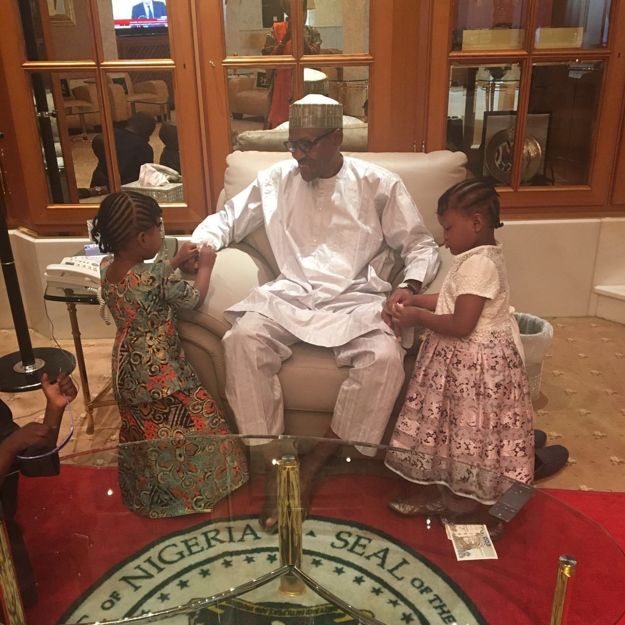 President Buhari getting his nails manicured by his granddaughters. (Photo: Twitter/Zaynab Kassim)