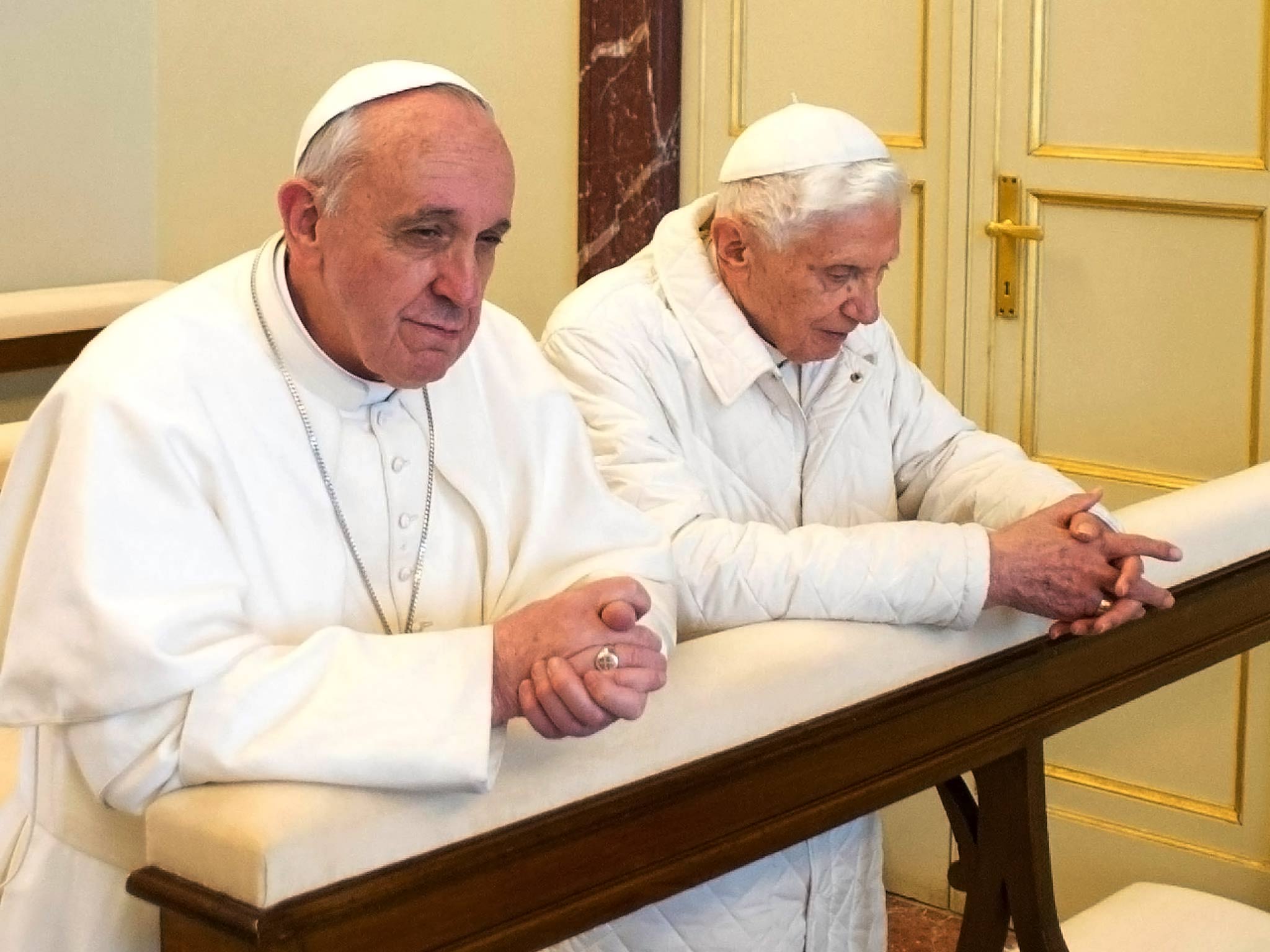 Pope Francis, left, and Pope Emeritus Benedict XVI praying together in 2013 (Photo: AP)